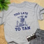 Too Late To Tan Skeleton At The Beach T-Shirt